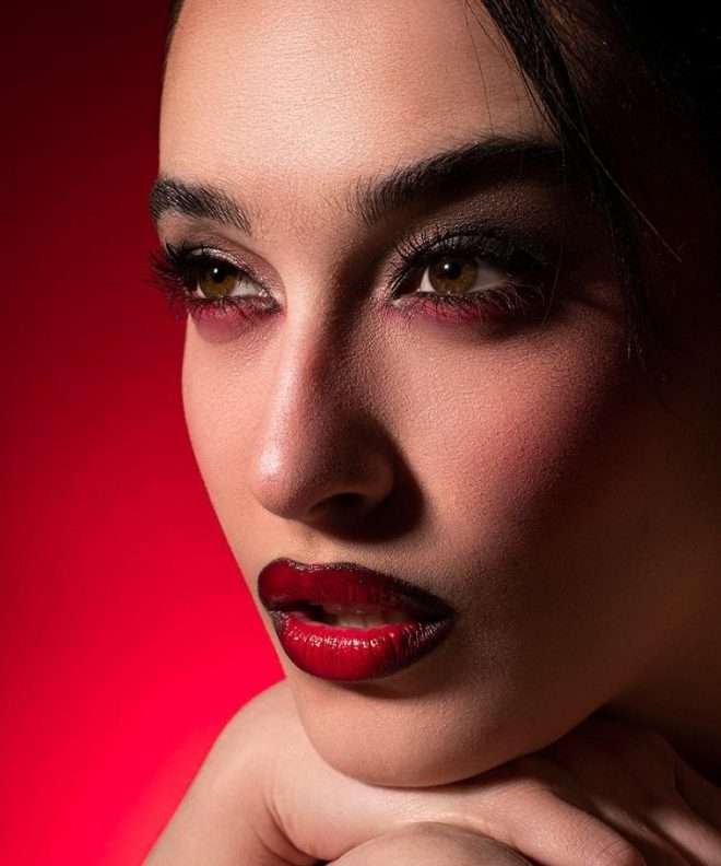 a person with red lipstick and red background